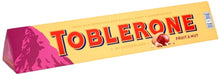 Toblerone Fruit & Nut, 400g. Chocolate con leche suizo con turrón de miel y almendras y pasas. La icónica barra triangular para compartir, regalar y disfrutar de una mezcla única. Toblerone - frontal